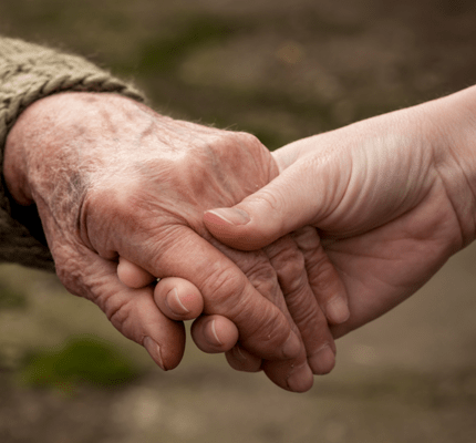 Older couple holding hands
