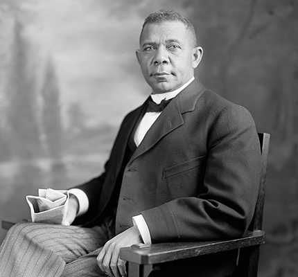 Booker T Washington sitting in a chair